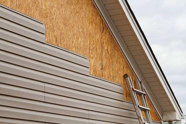 Professional Storm Damage Siding Repair technician working in Marshall, MN